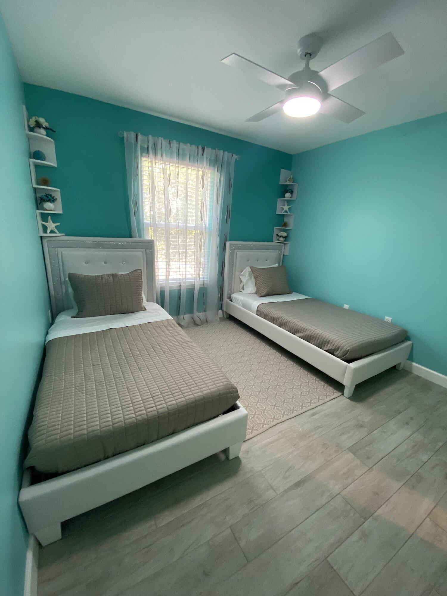1014 Airport Road, Unit 105 Destin, FL 32541 - Photo 7 of 12 a bedroom with a bed and window