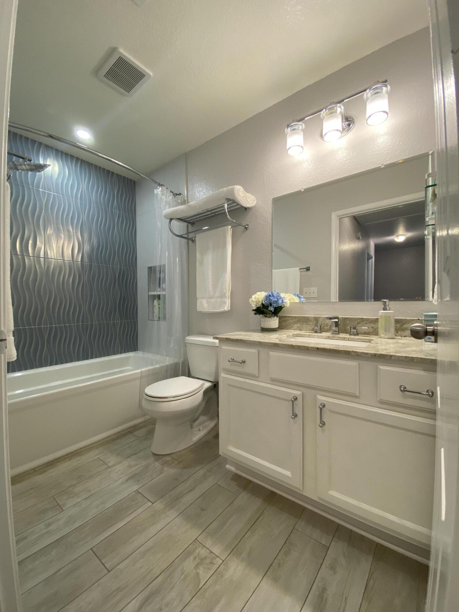 1014 Airport Road, Unit 105 Destin, FL 32541 - Photo 8 of 12 a bathroom with a sink a toilet and shower