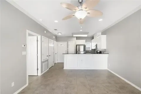 a view of kitchen with refrigerator and window