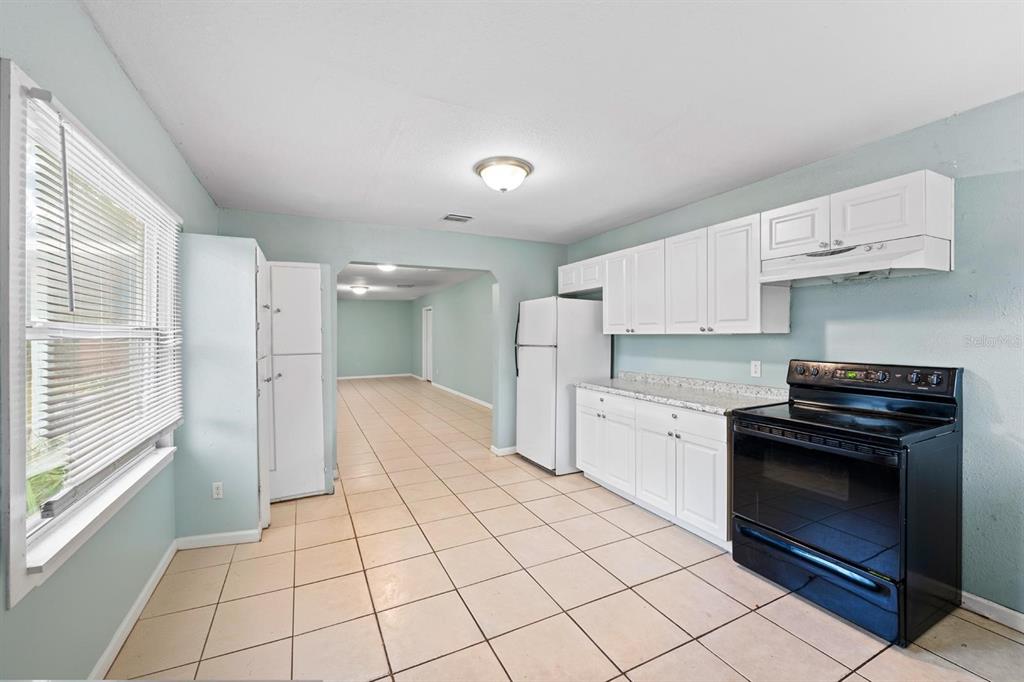 1846 Abacus Road Holiday, FL 34690 - Photo 6 of 20 a kitchen with stainless steel appliances a stove sink and cabinets