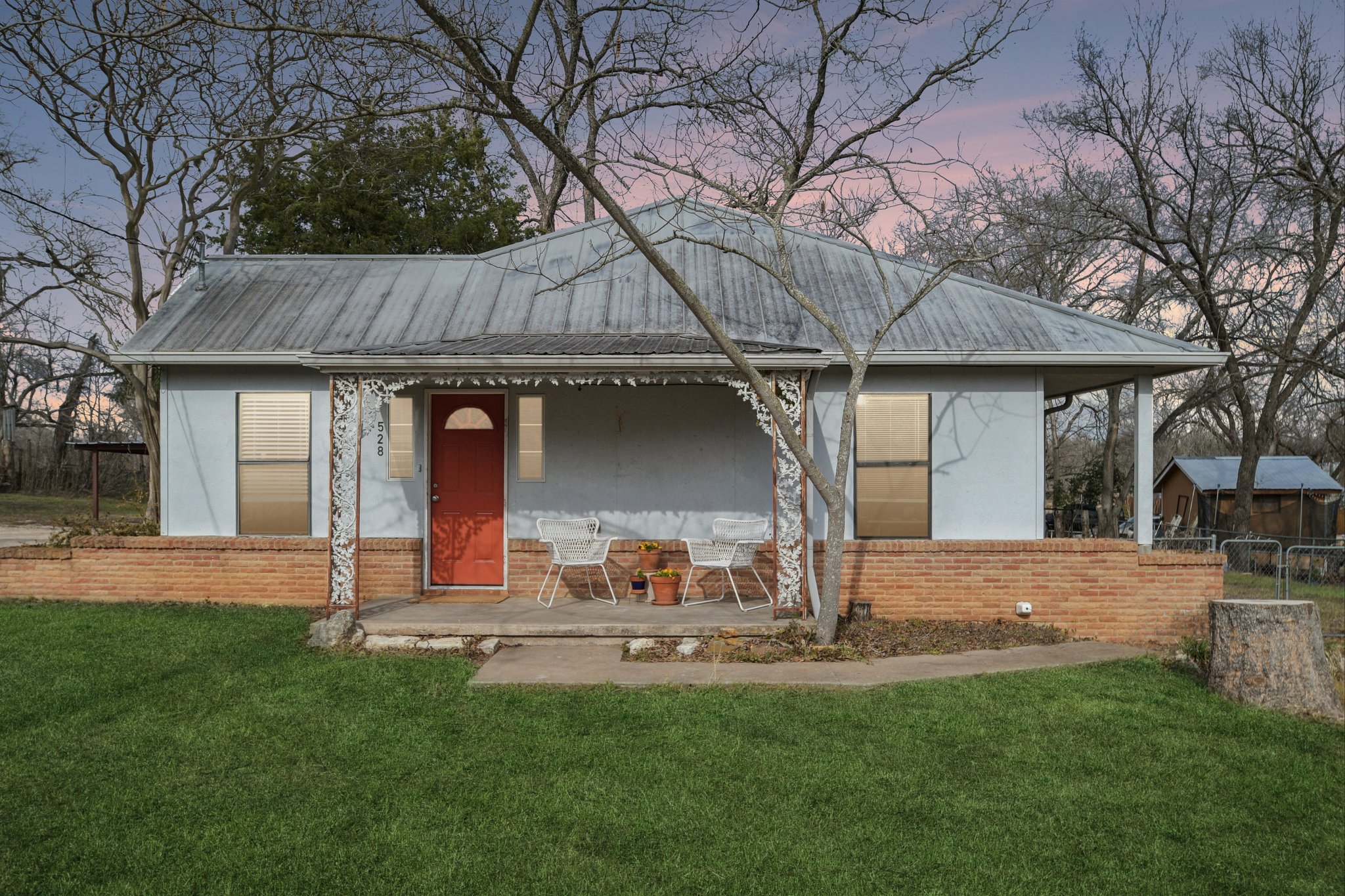 Virtual twilight shot of front of home and virtual green grass