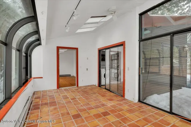 a bedroom with a bed and glass door