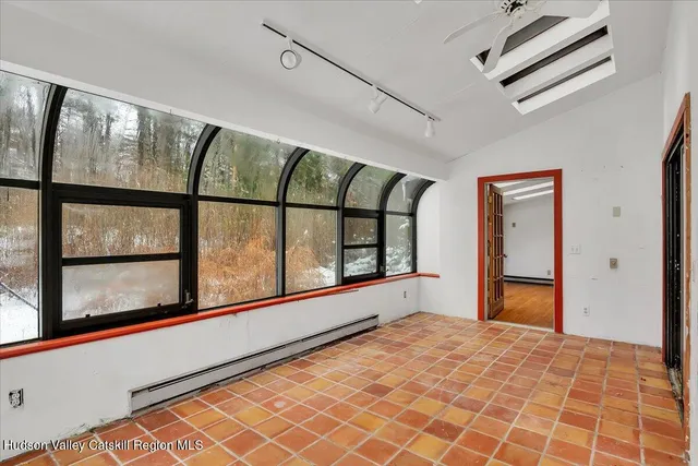 a bedroom with a bed and a large window