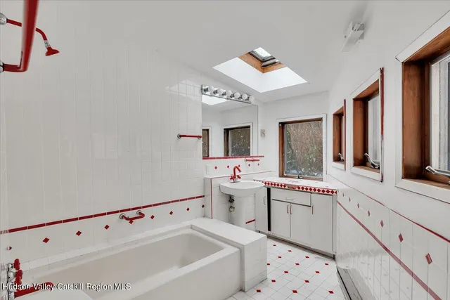 a large white room with a large window and sink