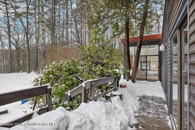 a view of a chairs and table in the balcony