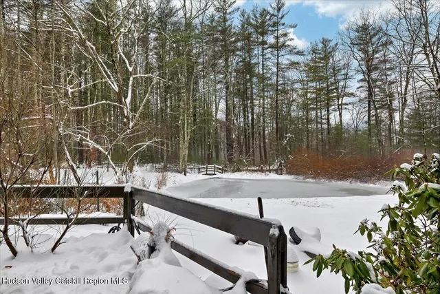 a swimming pool with outdoor seating and yard