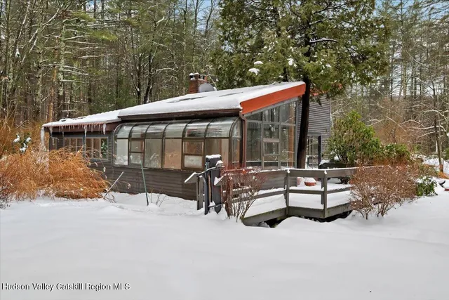 a view of a patio with table and chairs and floor to ceiling window