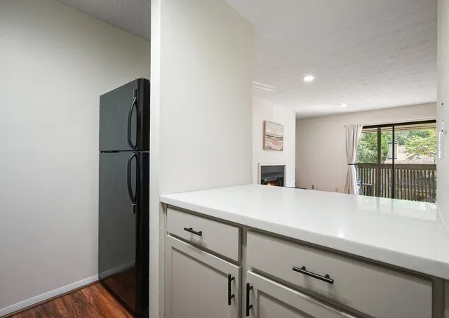 a room with a refrigerator and a window