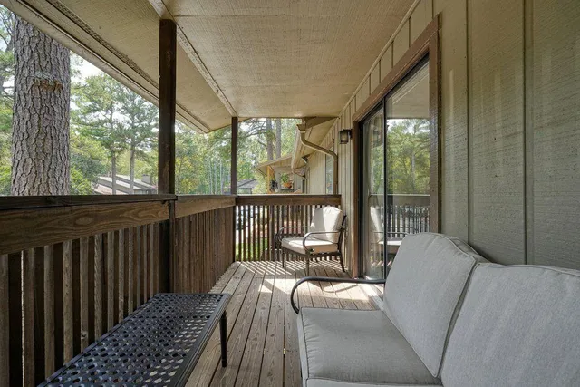 a bedroom with furniture and large windows