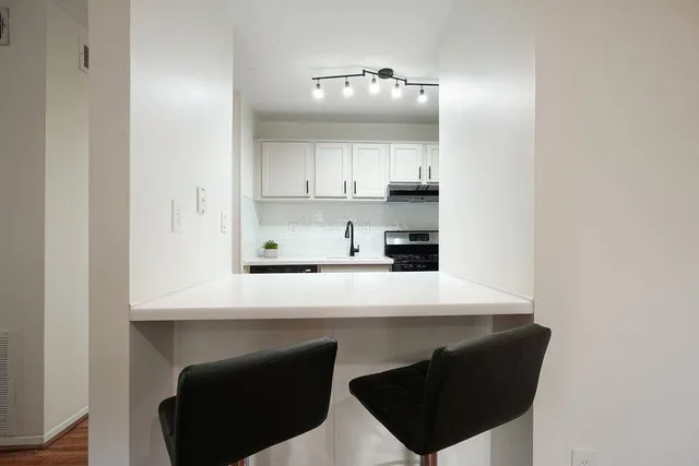 a kitchen with a sink cabinets and a window