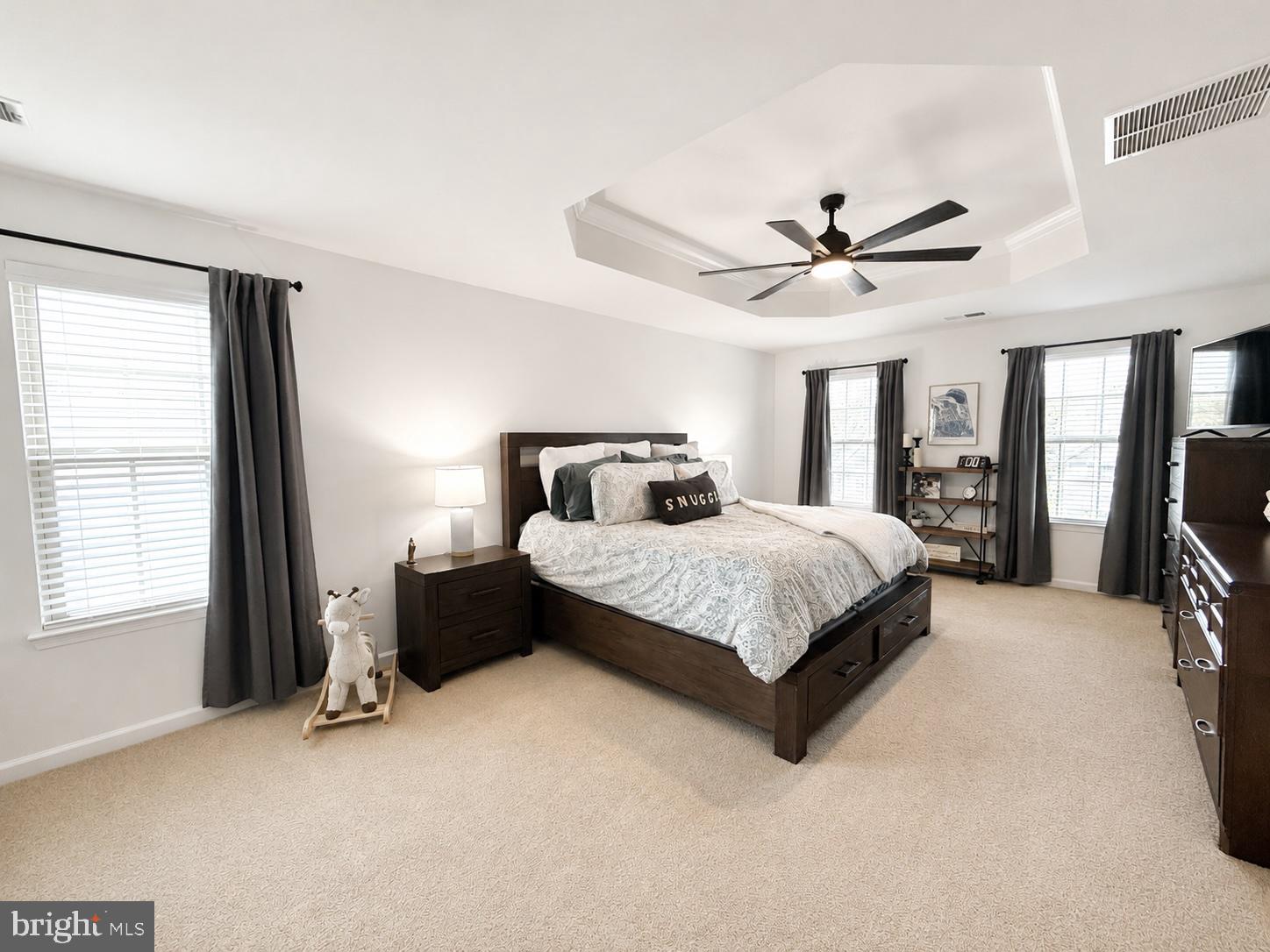 17875 Sugarberry Road Dumfries, VA 22026 - Photo 12 of 30 a bedroom with a large bed and a chandelier fan