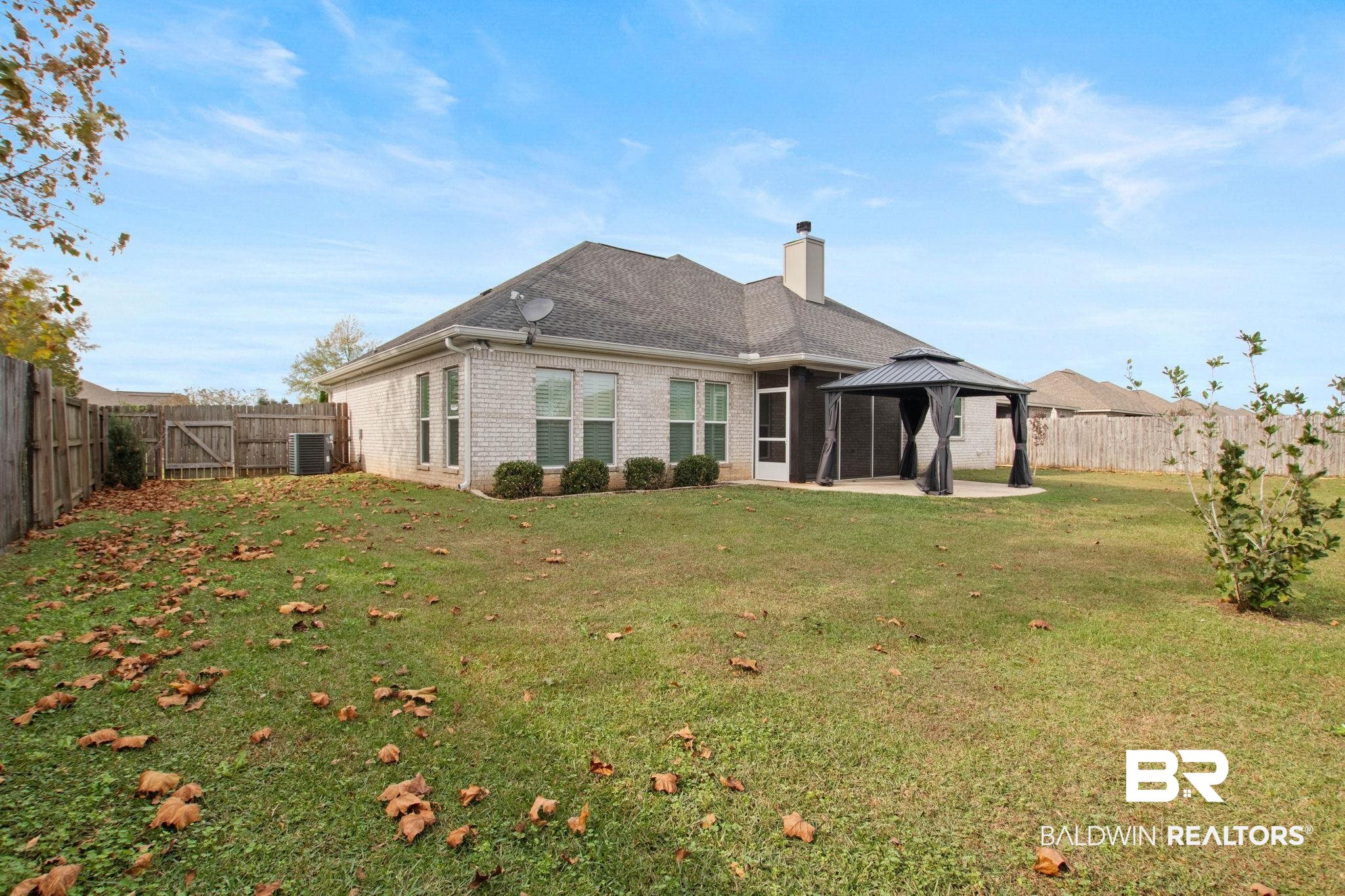17376 Bankhead Boulevard Fairhope, AL 36532 - Photo 58 of 73 Back of house featuring a patio area, a fenced backyard, a chimney, brick siding, and a gazebo