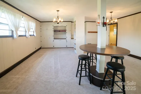 a view of a dining room with furniture and chandelier