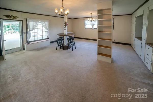 an empty room with windows and furniture