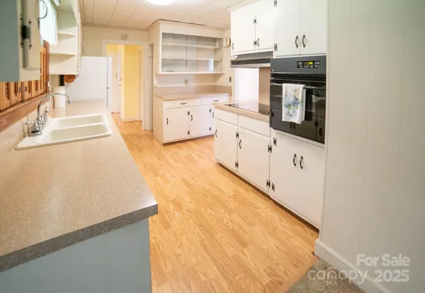 a kitchen with granite countertop a sink and cabinets