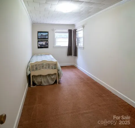 a spacious bedroom with a bed and a window