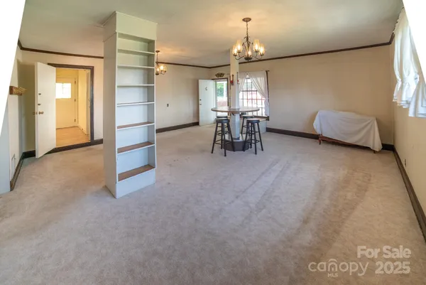 a view of a livingroom with furniture and chandelier