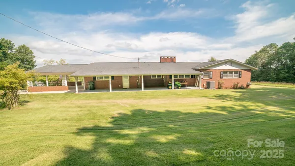 a house view with swimming pool in front of it