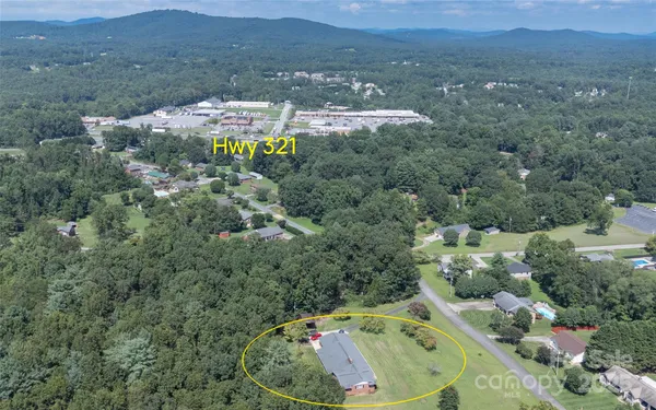 an aerial view of house with yard swimming pool and mountain view