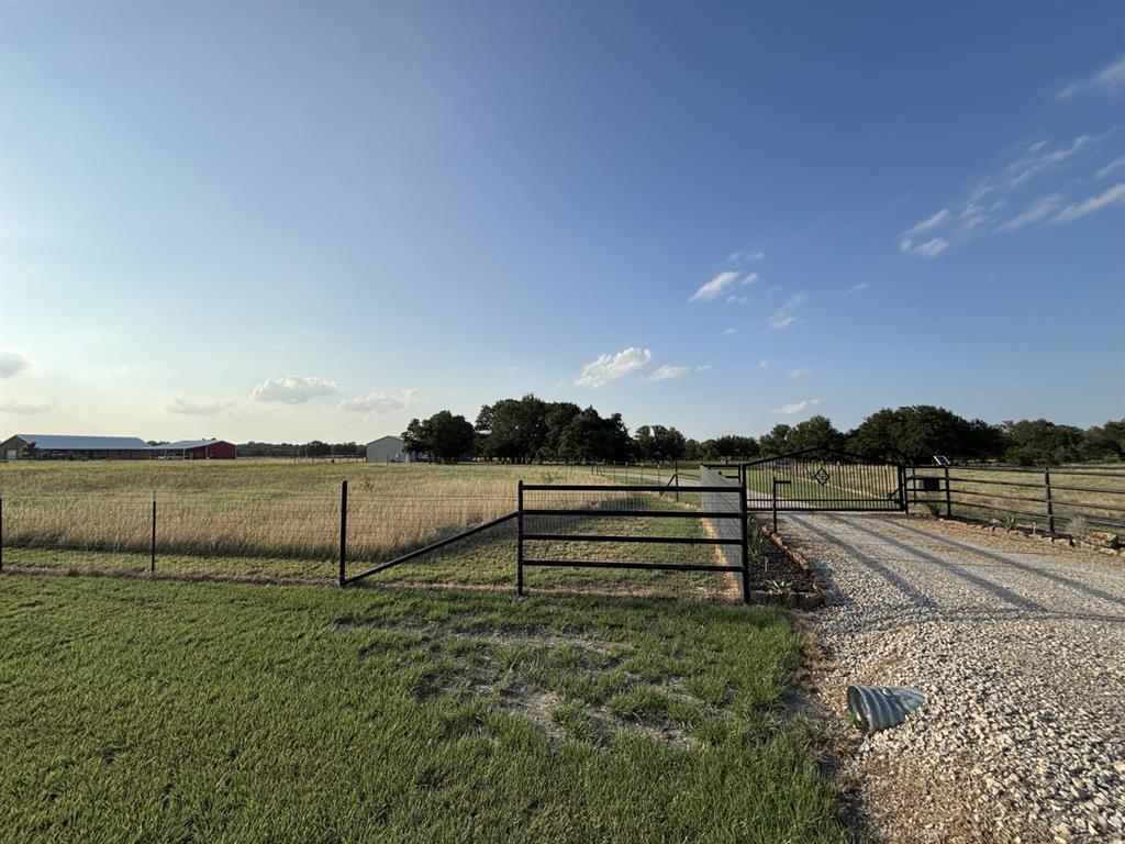 1020 Turkey Meadows Weatherford, TX 76088 - Photo 21 of 21 View of yard with a view of countryside, driveway, and a gate