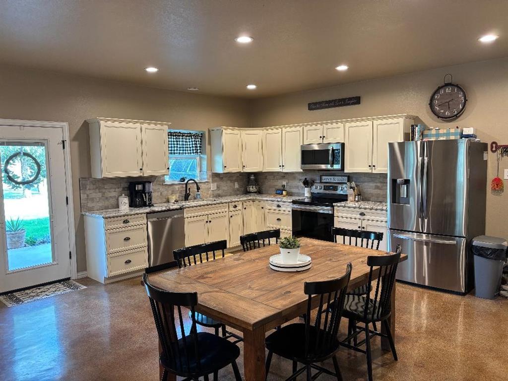 1020 Turkey Meadows Weatherford, TX 76088 - Photo 7 of 21 Kitchen with appliances with stainless steel finishes, tasteful backsplash, white cabinetry, and recessed lighting