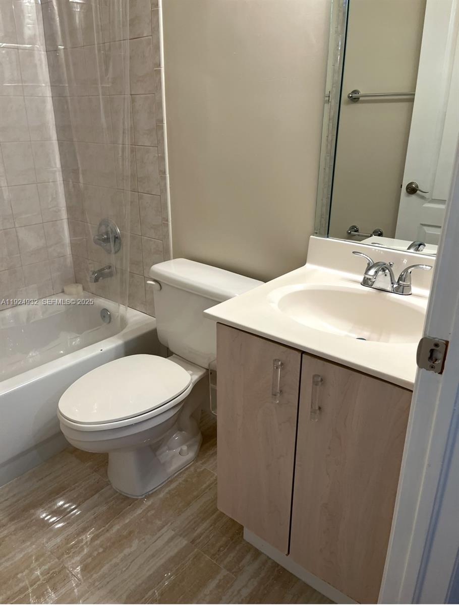 10150 Southwest 88th Street, Unit 103 Miami, FL 33176 - Photo 20 of 29 a bathroom with a sink a toilet and shower