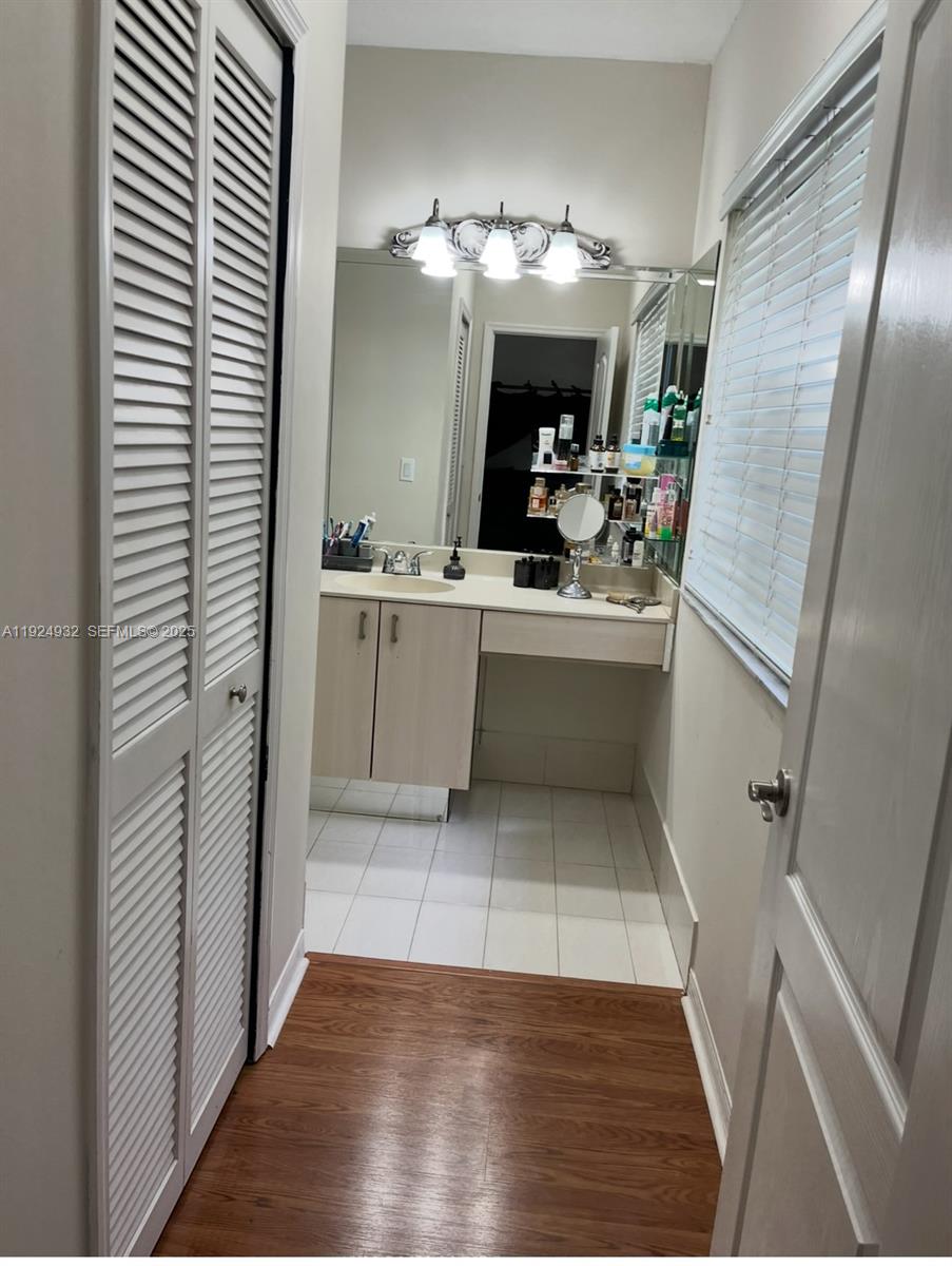 10150 Southwest 88th Street, Unit 103 Miami, FL 33176 - Photo 22 of 29 a view hallway a bathroom with a sink a mirror and a shower