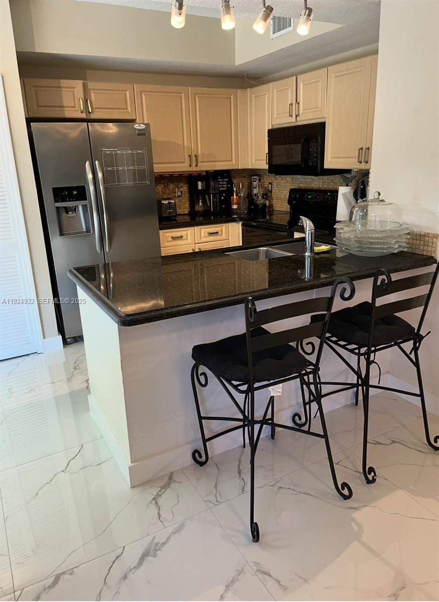 10150 Southwest 88th Street, Unit 103 Miami, FL 33176 - Photo 3 of 29 a living room with stainless steel appliances furniture a rug and a view of kitchen