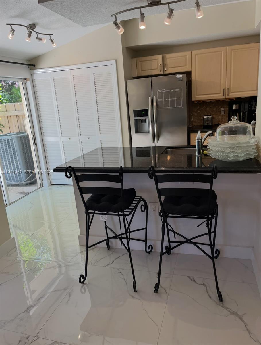 10150 Southwest 88th Street, Unit 103 Miami, FL 33176 - Photo 4 of 29 a living room with furniture and a flat screen tv