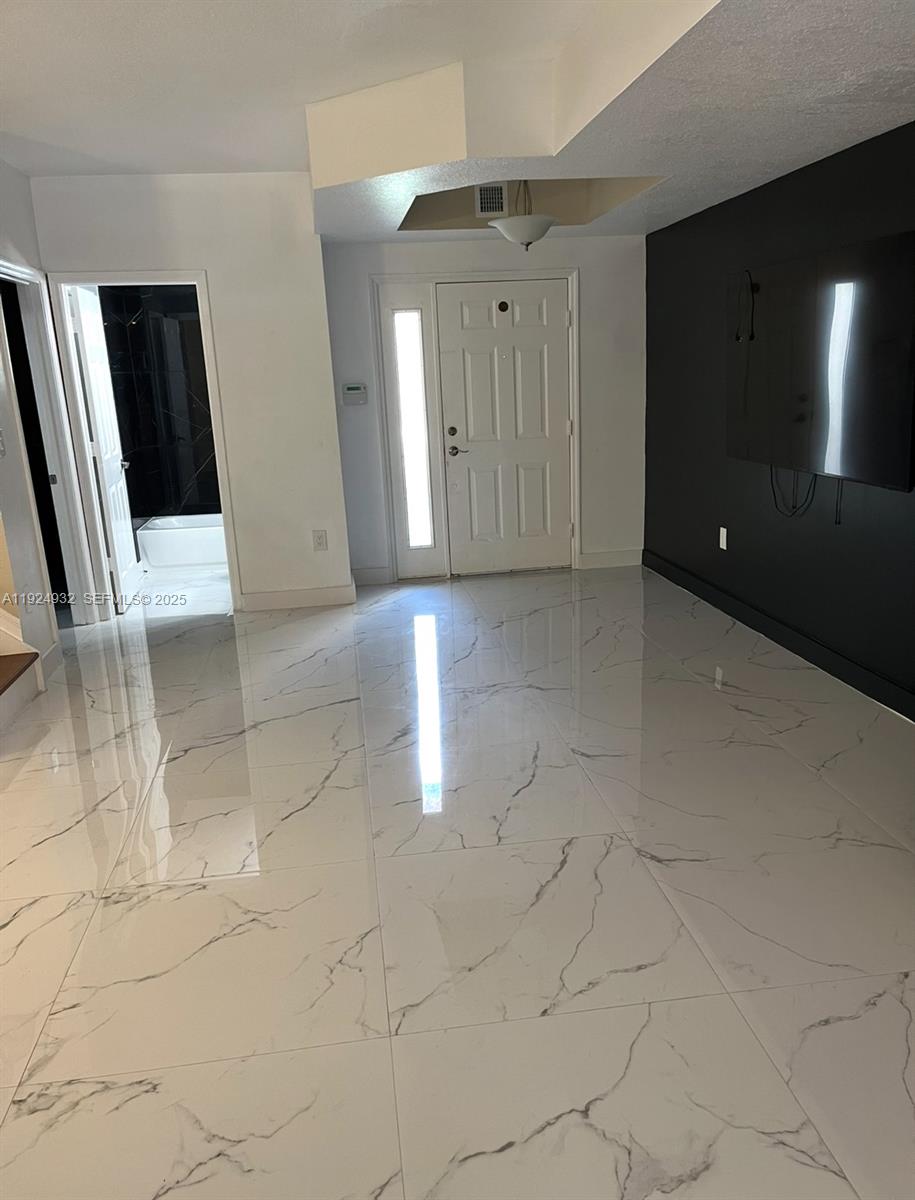 10150 Southwest 88th Street, Unit 103 Miami, FL 33176 - Photo 7 of 29 a view of a hallway with entryway