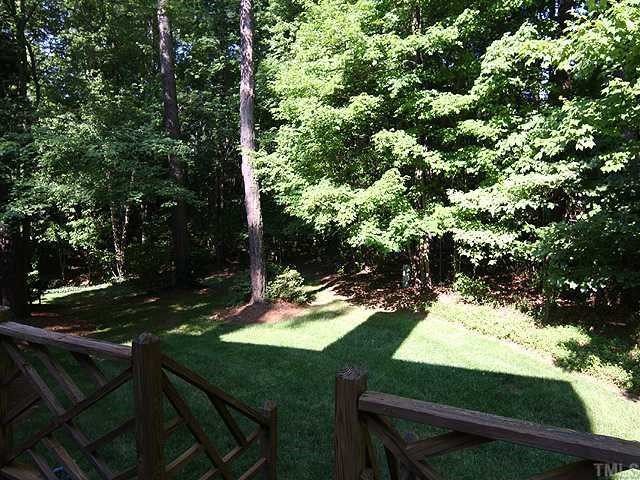 1318 Slatestone Court Raleigh, NC 27615 - Photo 11 of 12 a backyard of a house with yard and outdoor seating
