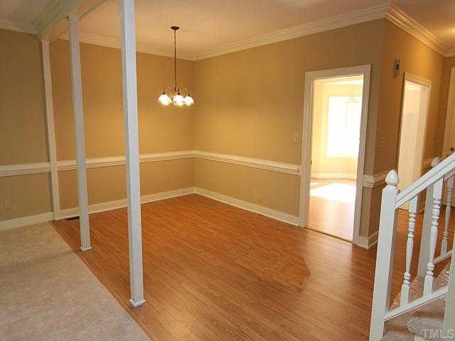 1318 Slatestone Court Raleigh, NC 27615 - Photo 3 of 12 a view of a room with wooden floor and white walls