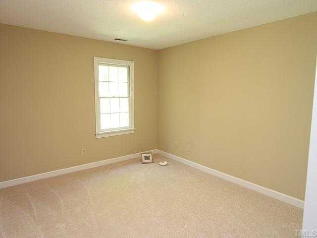 1318 Slatestone Court Raleigh, NC 27615 - Photo 9 of 12 an empty room with windows