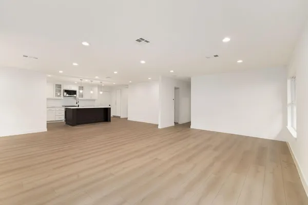 a view of kitchen and stainless steel appliances with wooden floor