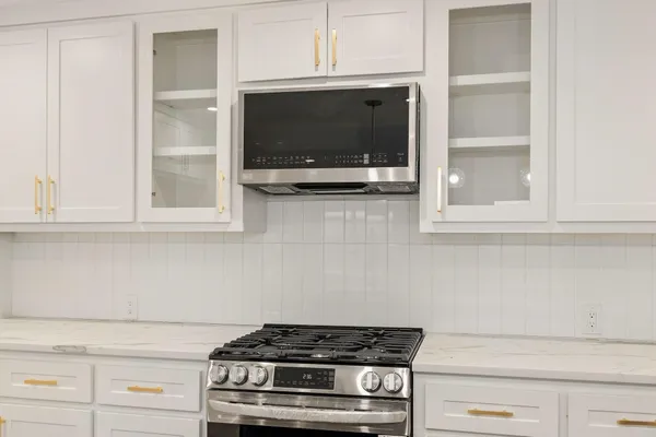 a stove top oven sitting inside of a kitchen
