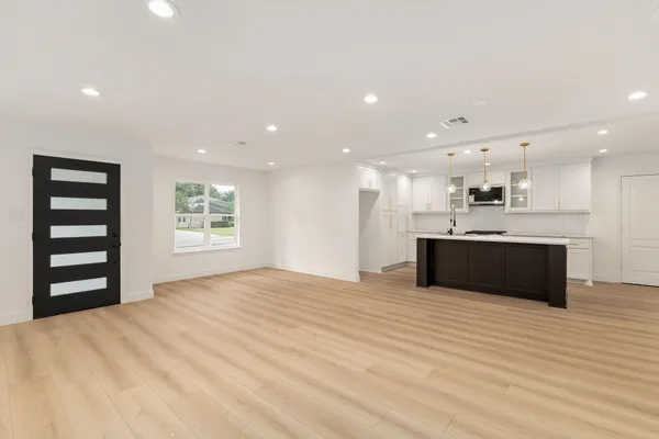 a large kitchen with kitchen island a sink stainless steel appliances and cabinets