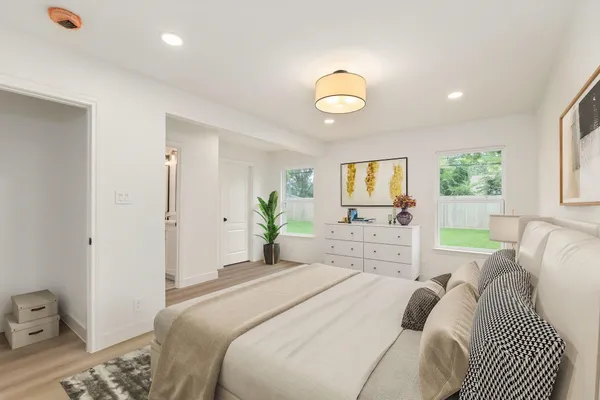 a bedroom with a bed and a window