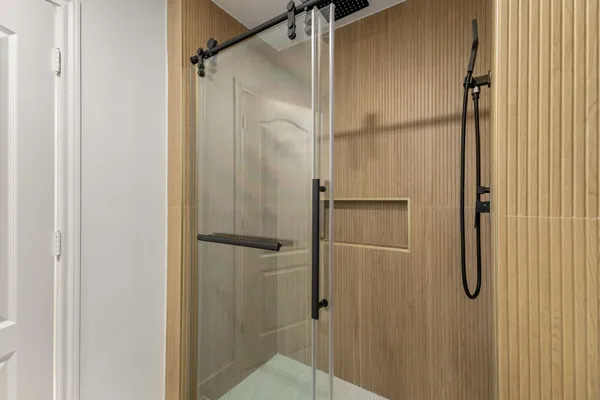 a bathroom with a glass shower door