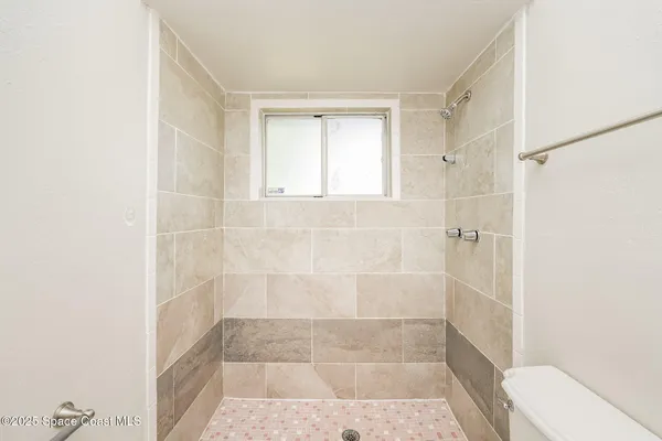a bathroom with a shower and a toilet