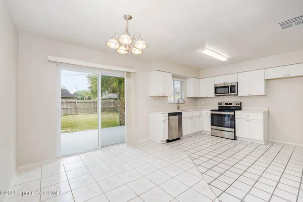 a kitchen with stainless steel appliances a stove sink and microwave