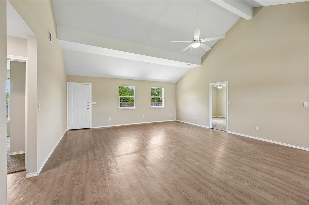 433 Whitney Court Rio Vista, TX 76093 - Photo 3 of 27 an empty room with wooden floor and windows