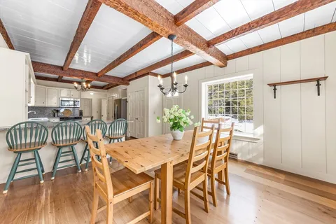 a dining room with furniture and window