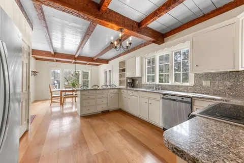 a kitchen with stainless steel appliances granite countertop a stove and cabinets