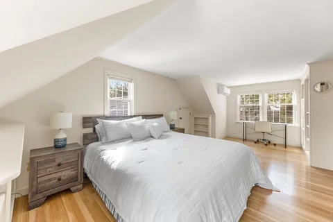 a bed room with a bed and wooden floor