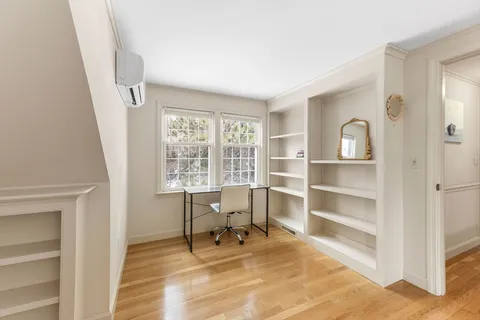 a view of a livingroom with a chair and a large window