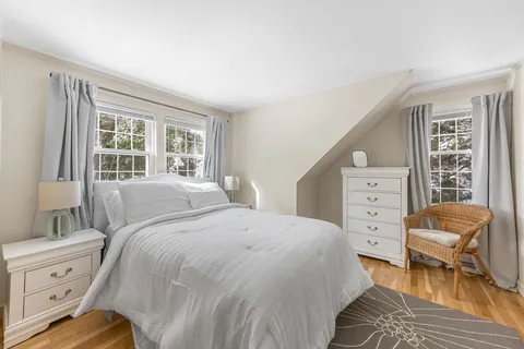 a bedroom with a bed and a chair
