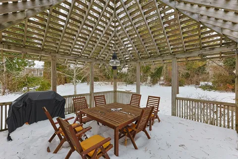 a backyard of a house with table and chairs