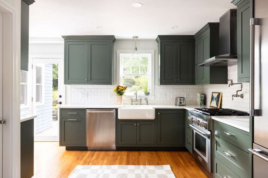 18 Wolcott Road Brookline, MA 02467 - Photo 4 of 19 a kitchen with stainless steel appliances granite countertop a sink stove and refrigerator