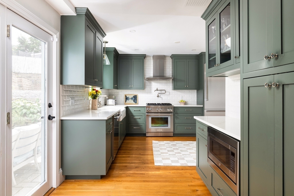 18 Wolcott Road Brookline, MA 02467 - Photo 5 of 19 a kitchen with stainless steel appliances granite countertop a stove a sink and a refrigerator