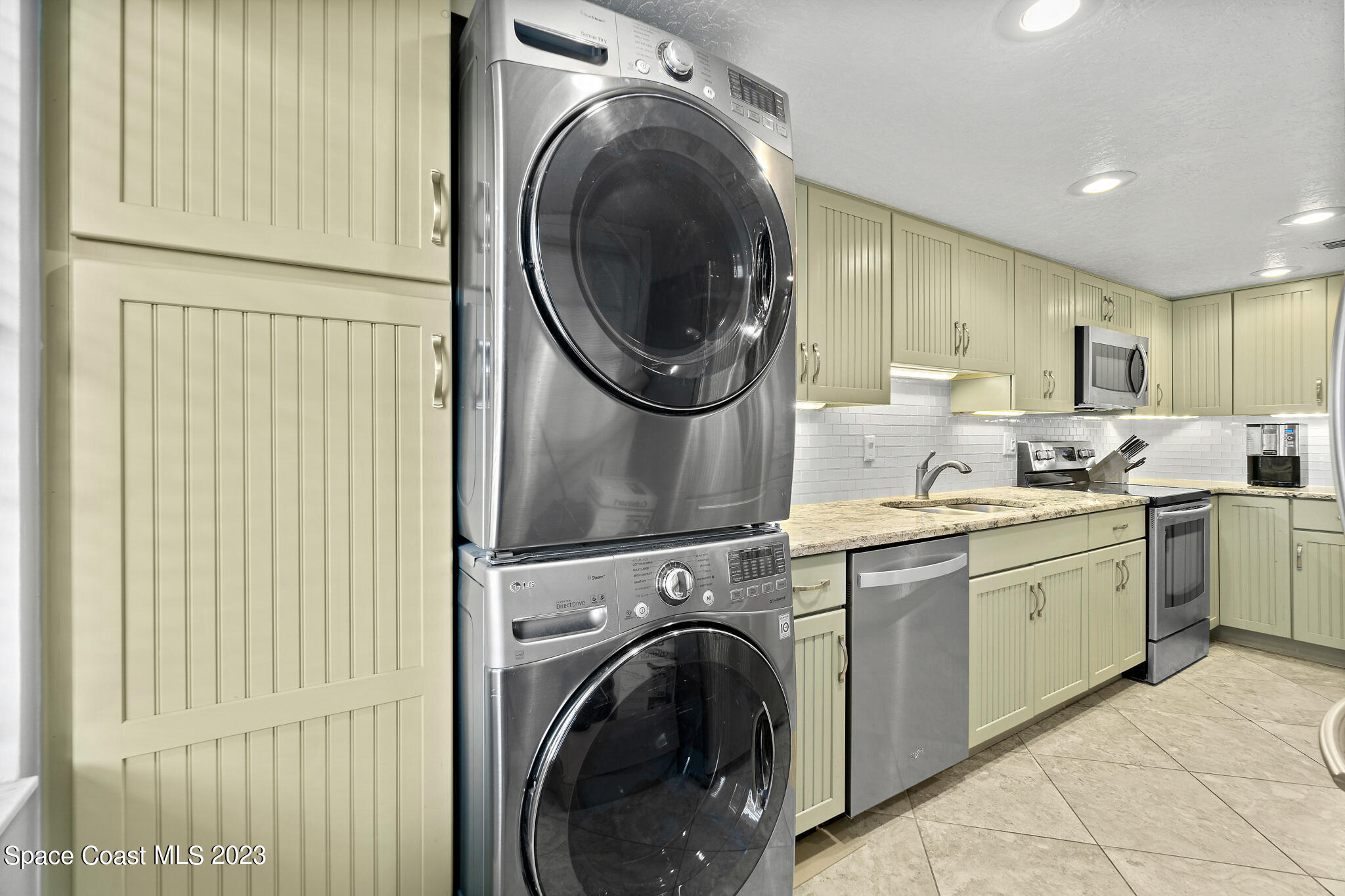 500 Catalina Road, Unit 103 Cocoa Beach, FL 32931 - Photo 9 of 28 a view of a kitchen with washer and dryer
